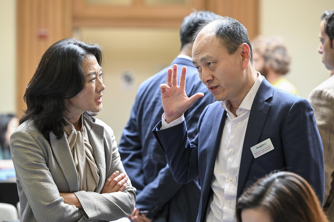 Hongbin Li speaks with an audience member at the China Conference.