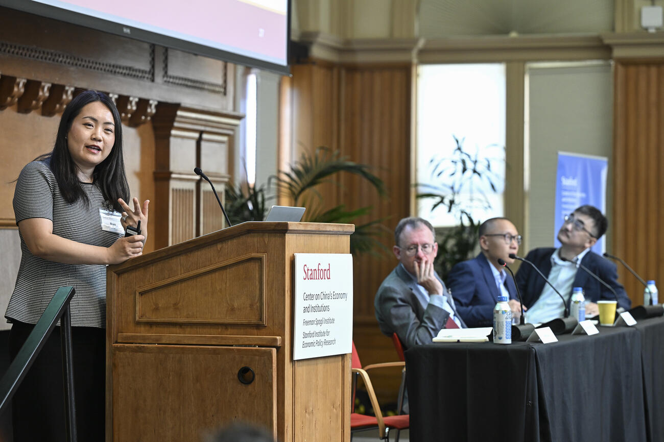 Jia Nan speaks at the podium during a panel session at the SCCEI China Conference.