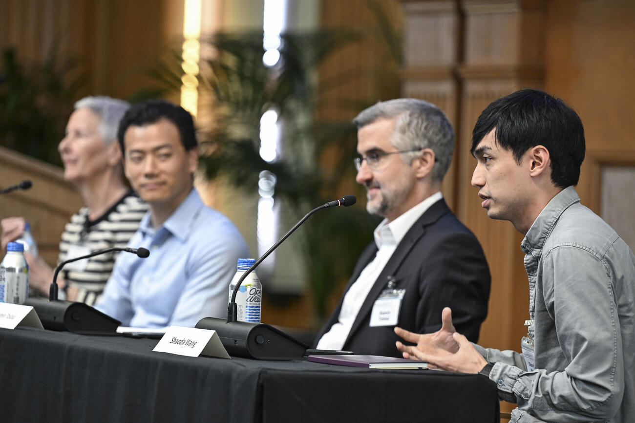 Shaoda Wang speaks on a panel during a conference.