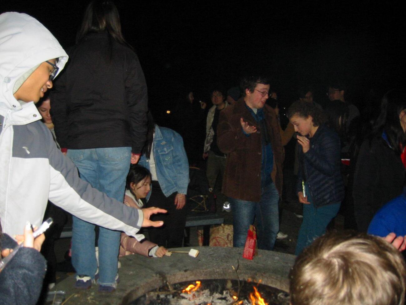 Students from the Forum for American-Chinese Exchange at Stanford at an evening bonfire.