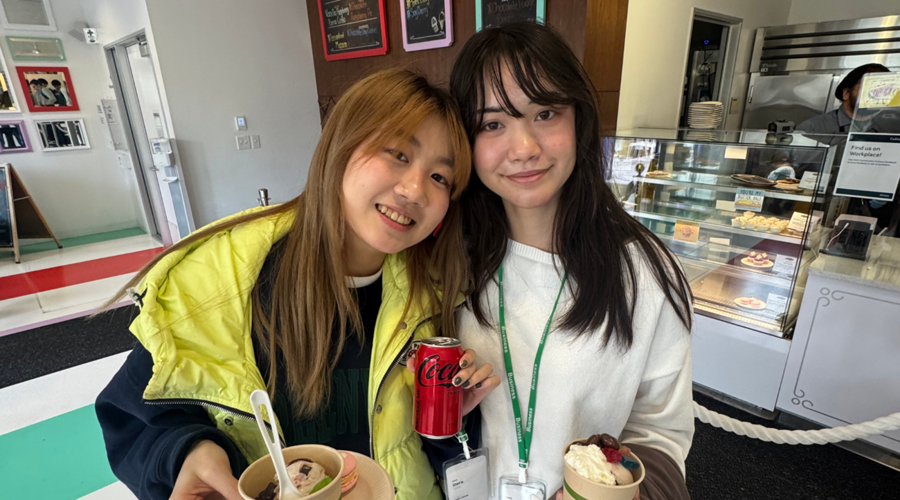 Two students from the Stanford Japan Exchange Conference pose together with frozen desserts.