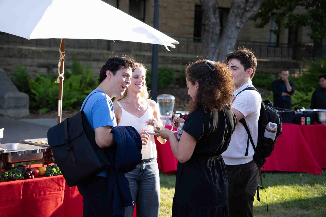 A group of alumni of the Ford Dorsey Master's in International Policy chat together during an annual convening of program alumni.