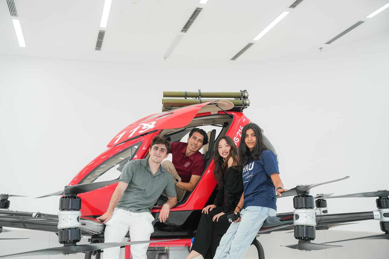 Students pose with a model helicopter.