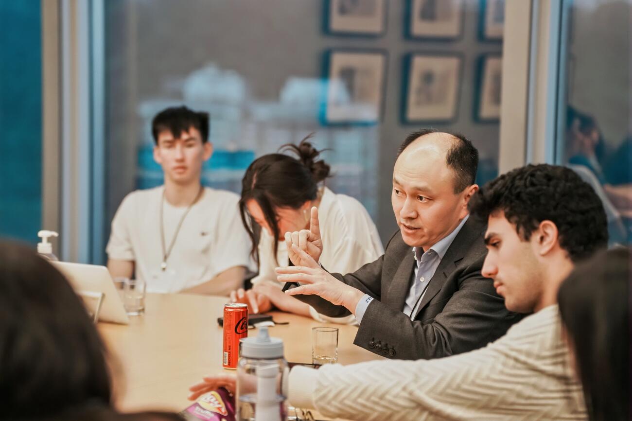 Hongbin Li in discussion with students.