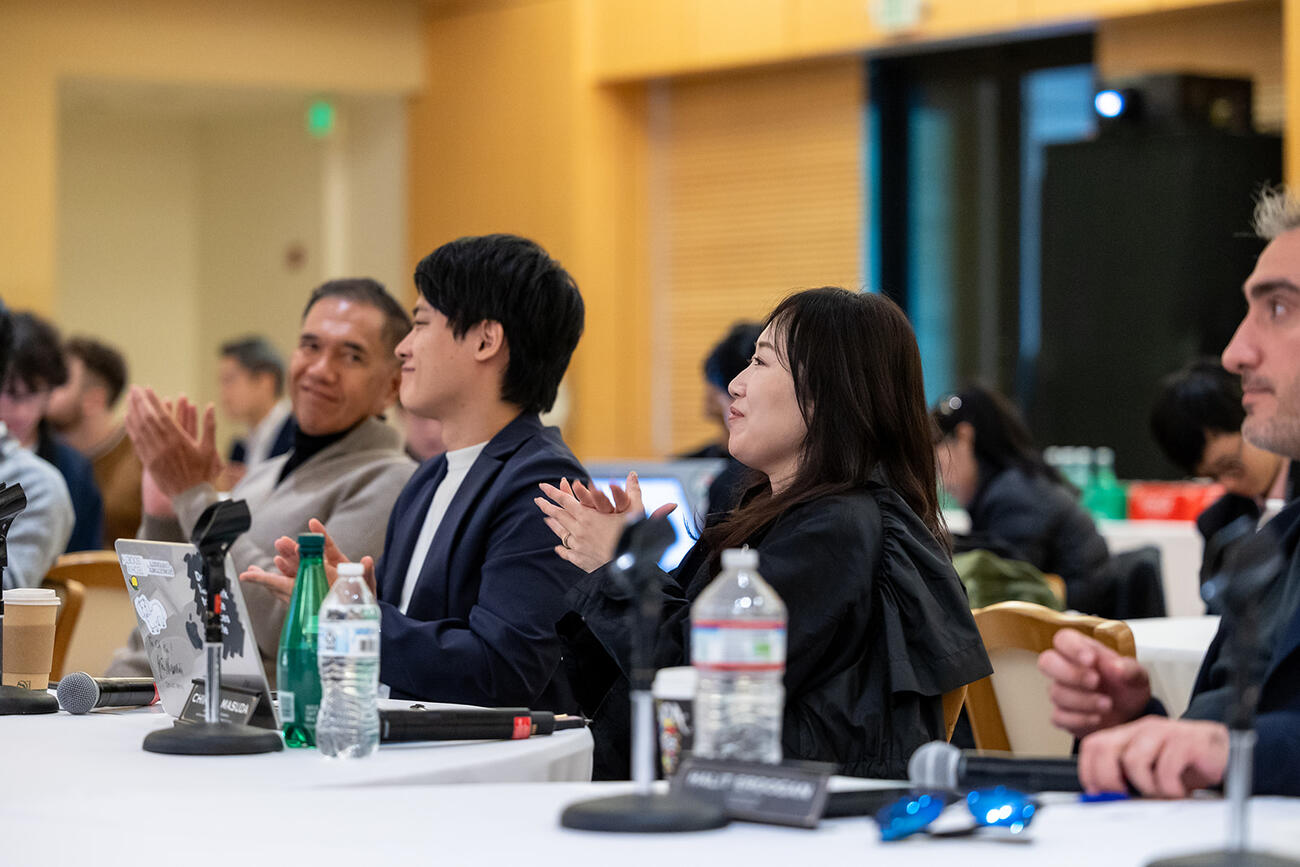 Participants at the 2025 Sushi Hackathon listeningn to student presentations.