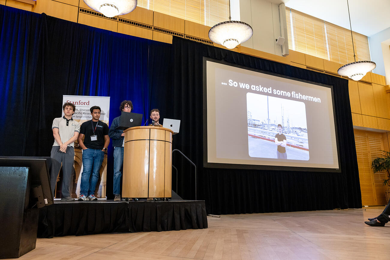 Students present at a lectern.