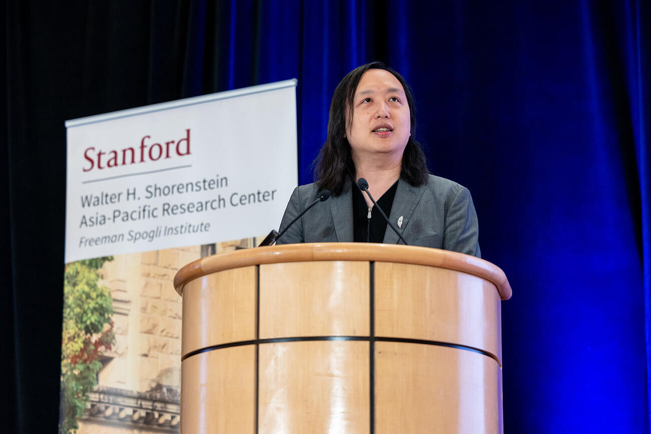 Audrey Tang delivers remarks at a lectern.