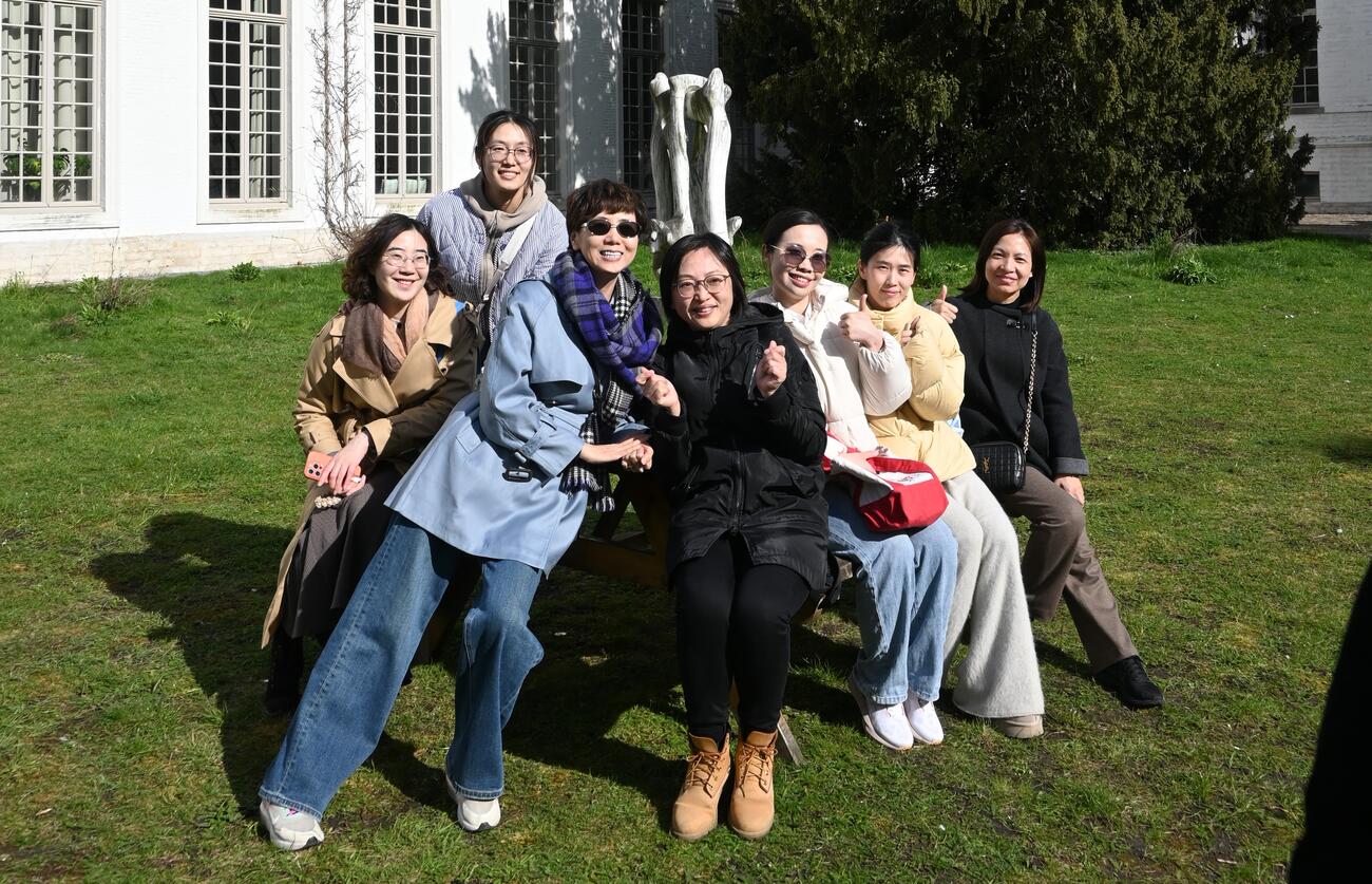 People pose in front of a building in Leuven.