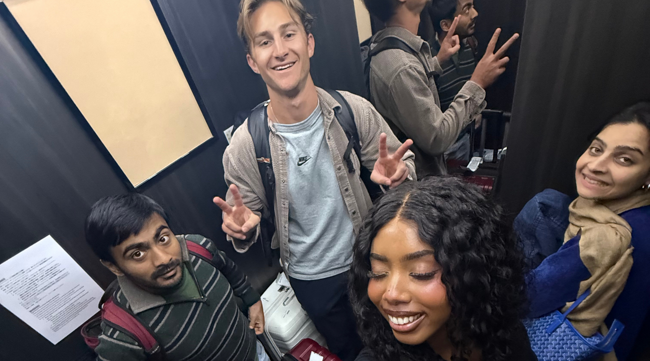 MIP Ashraf Sabkha, Humzah Khan, Kylie Jones, and Luke Anderson pose in an elevator in Tokyo, Japan.