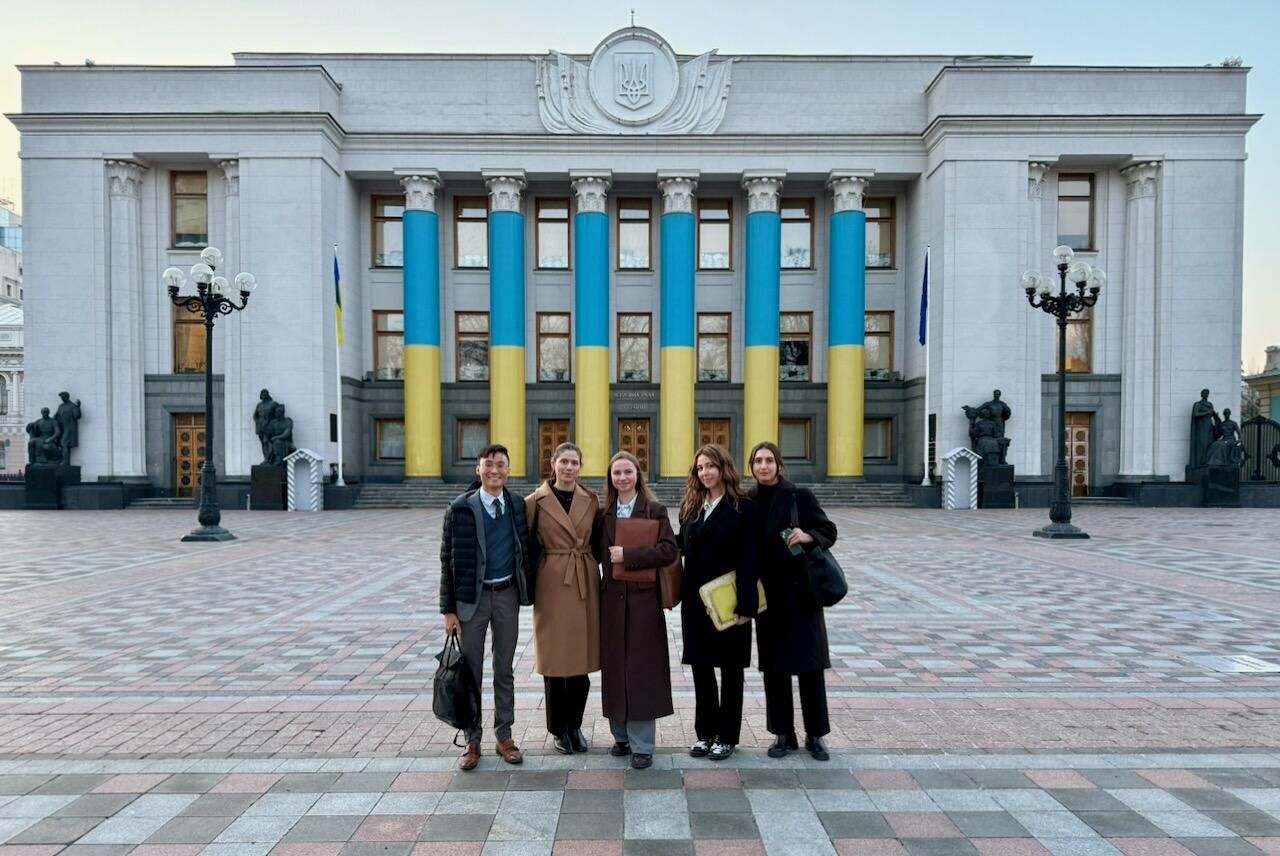MIP students Gabriela Sommer, Haolie Jiang, Ren Jie Teoh, and Sophia Yushchenko with their hosts outside the main government buildings in Constitution Square in Kyiv, Ukraine.