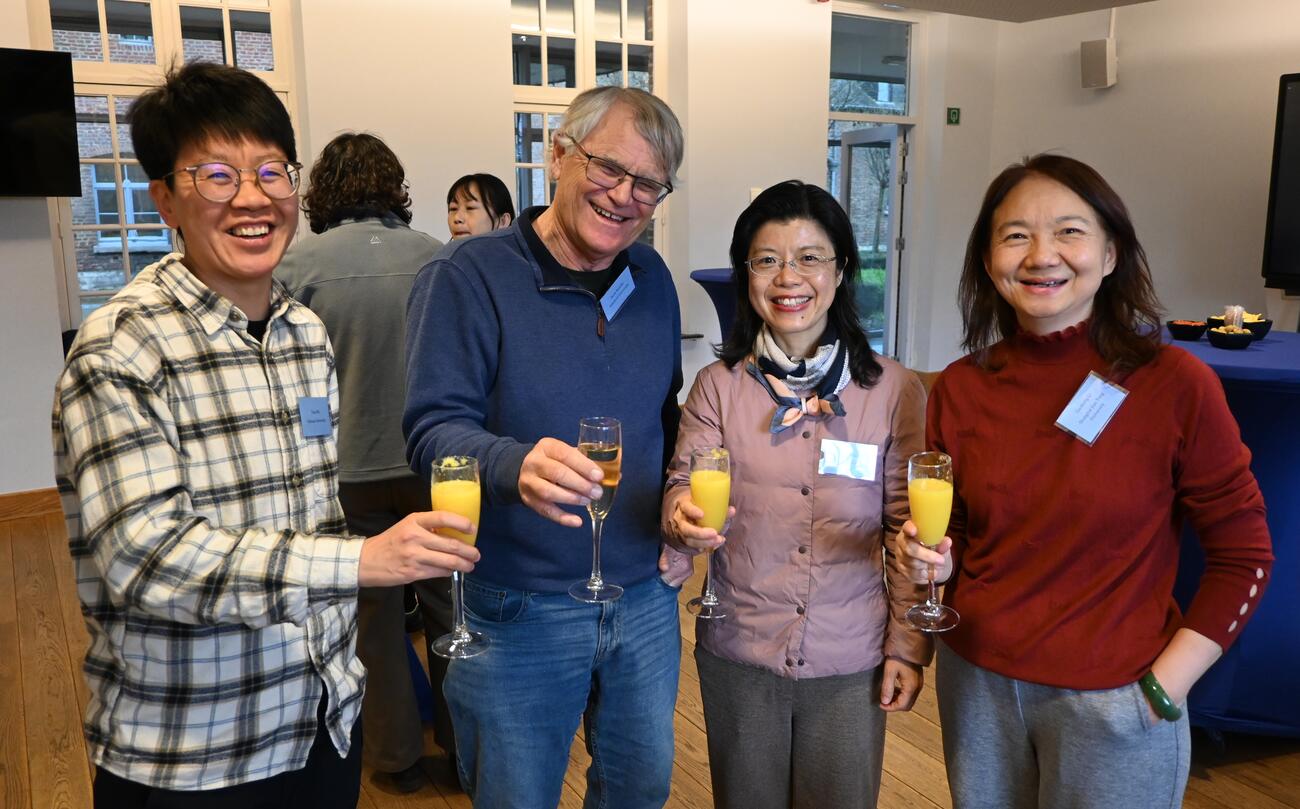 People pose with champagne glasse at a reception.