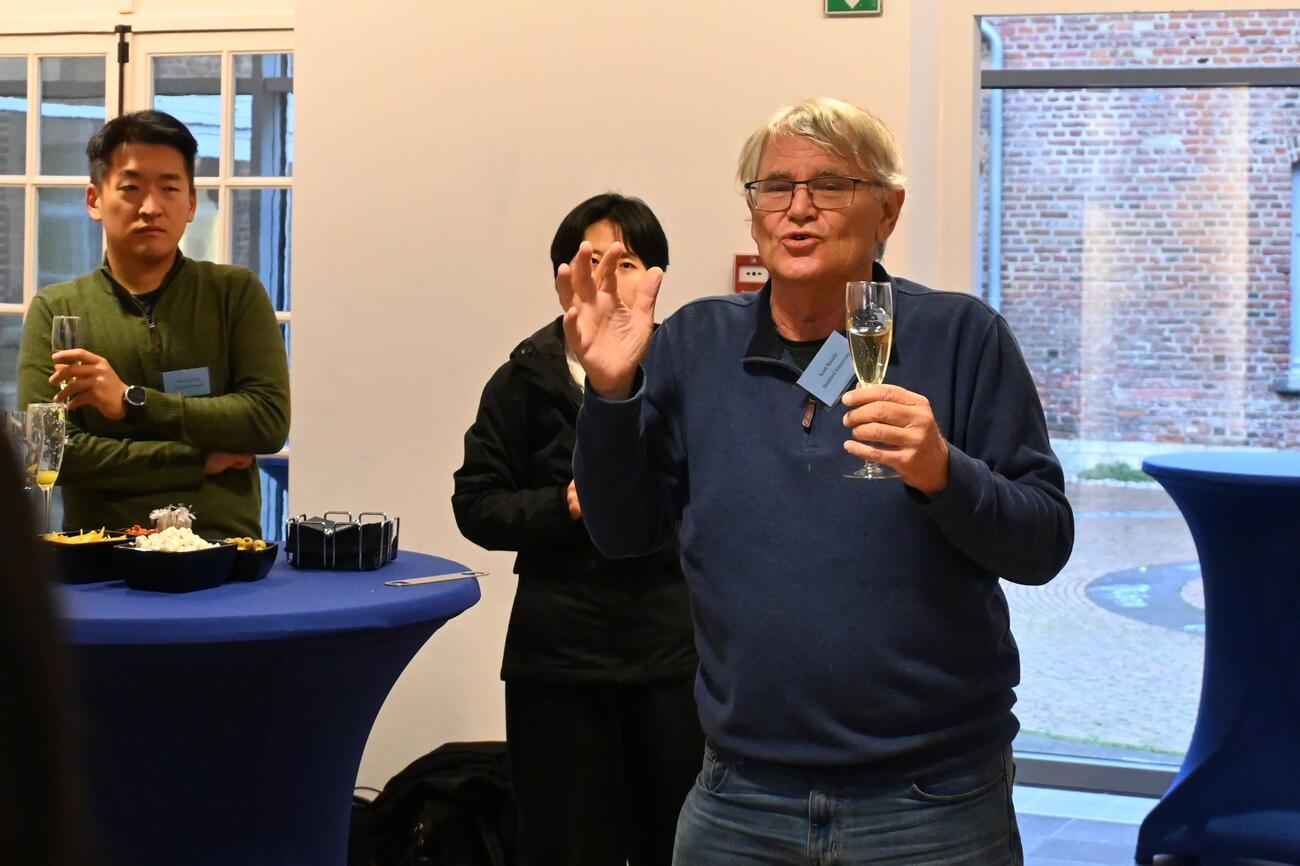 Scott Rozelle speaks with a glass of champagne in hand.