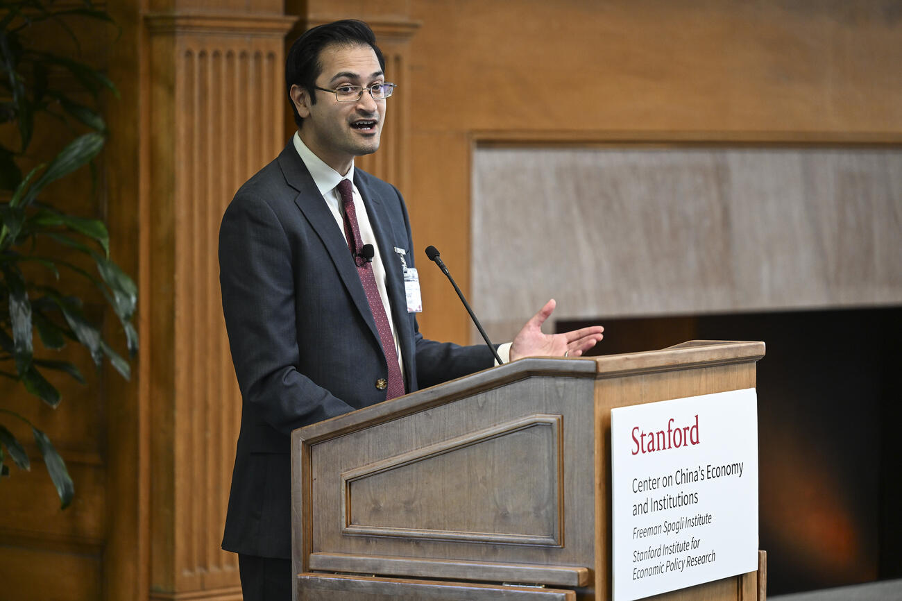 Rush Doshi speaks behind a podium at the SCCEI China Conference