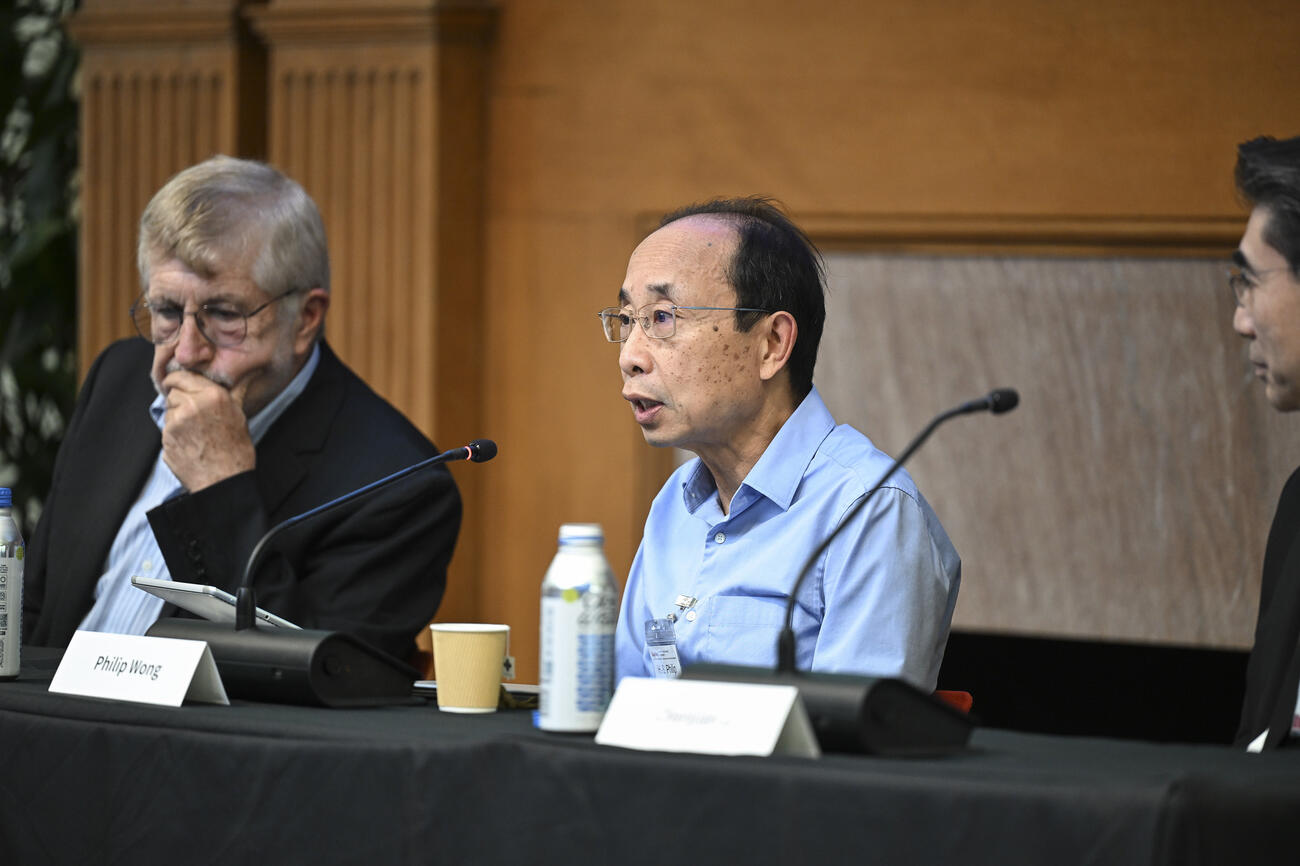 Philip Wang speaks on a panel at a conference.