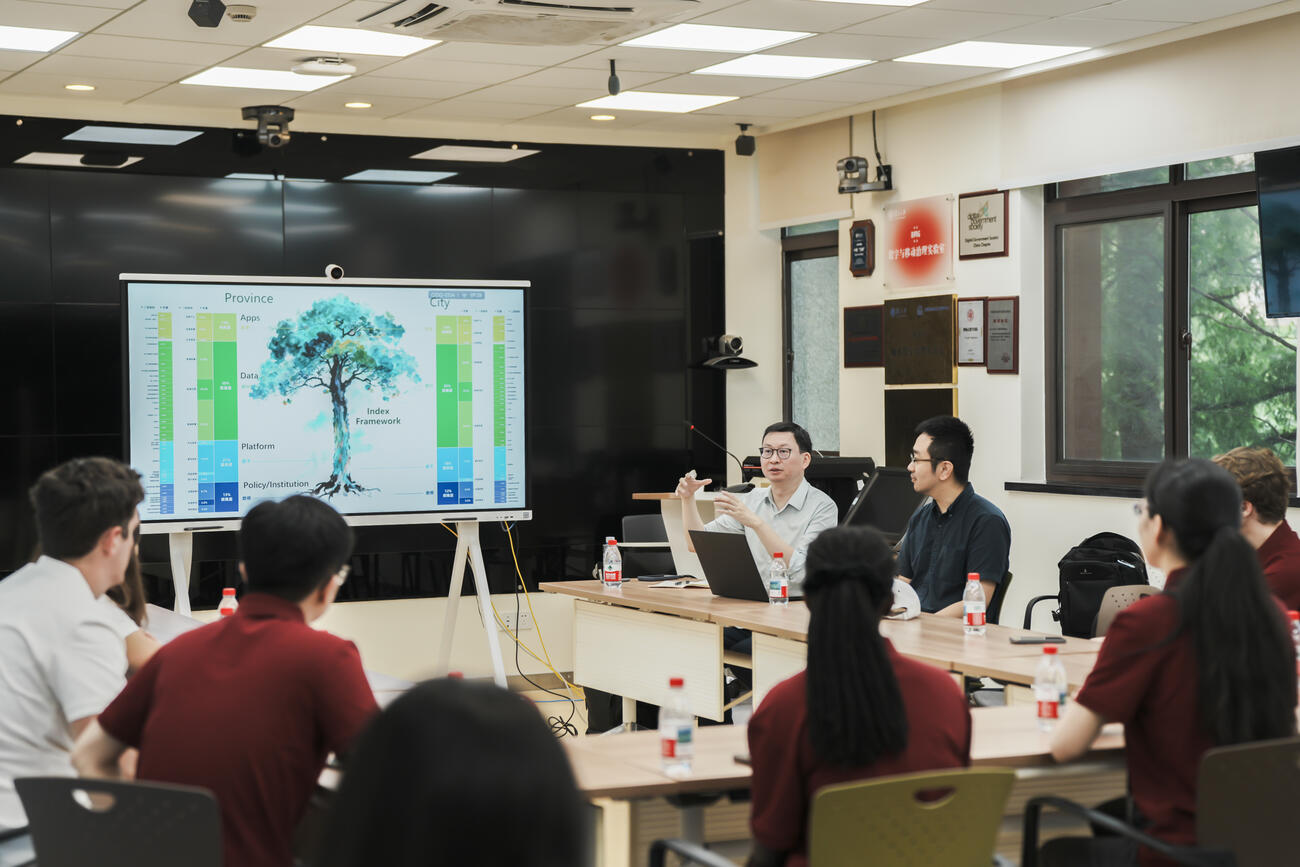 Students sit and listen to a presentation at Fudan University. 