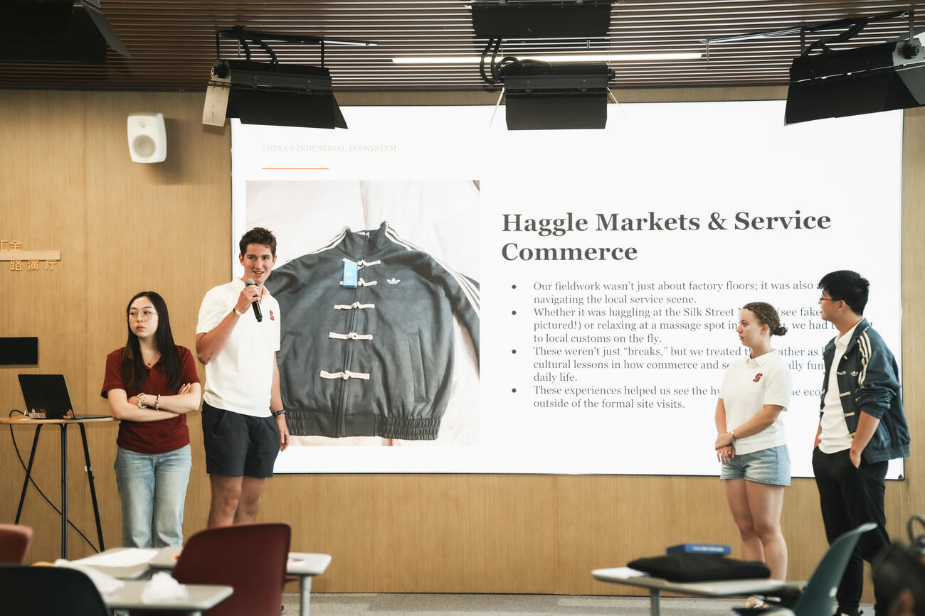 Students present in front of a classroom.