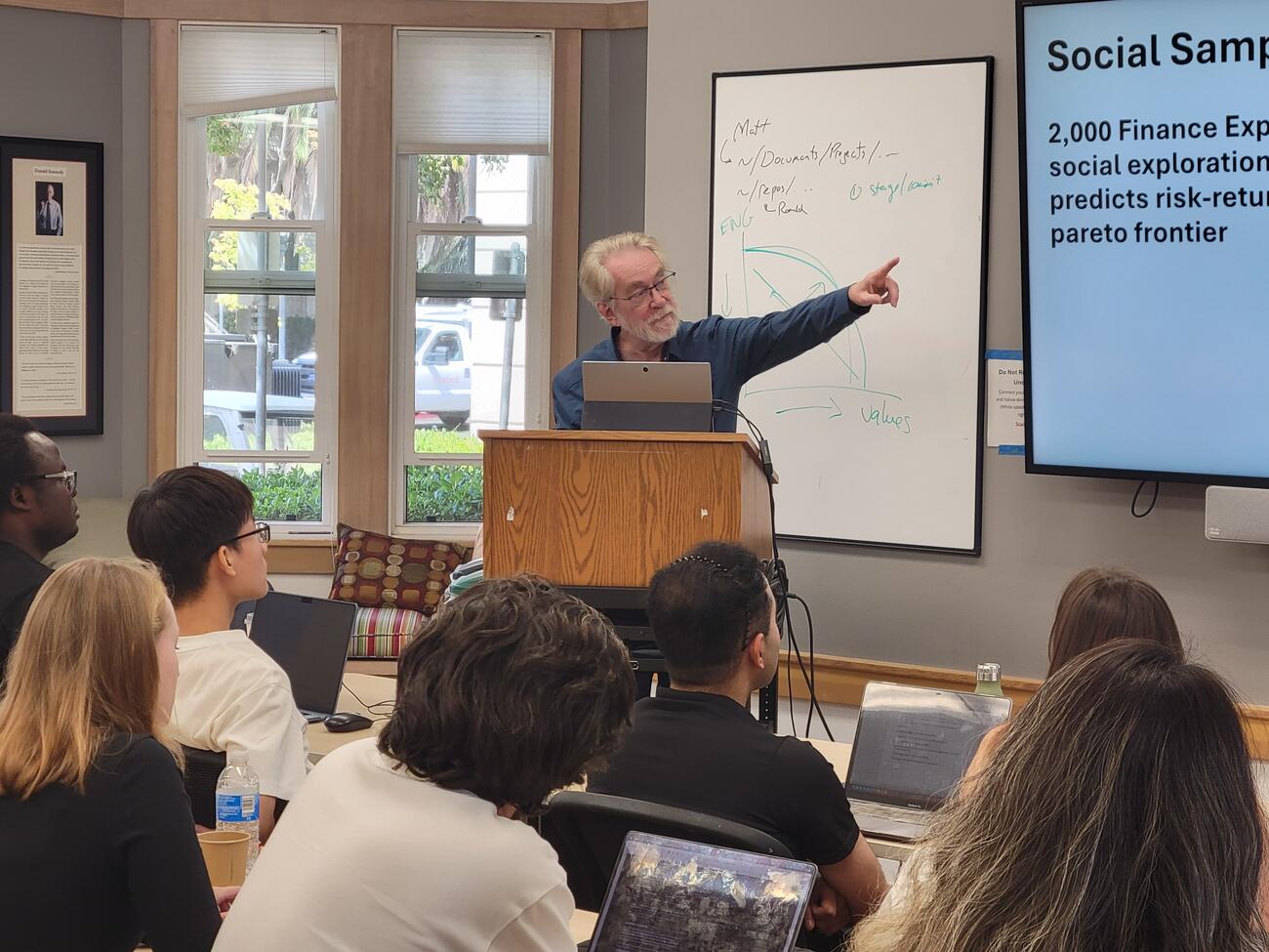 a presenter gesturing at a presentation
