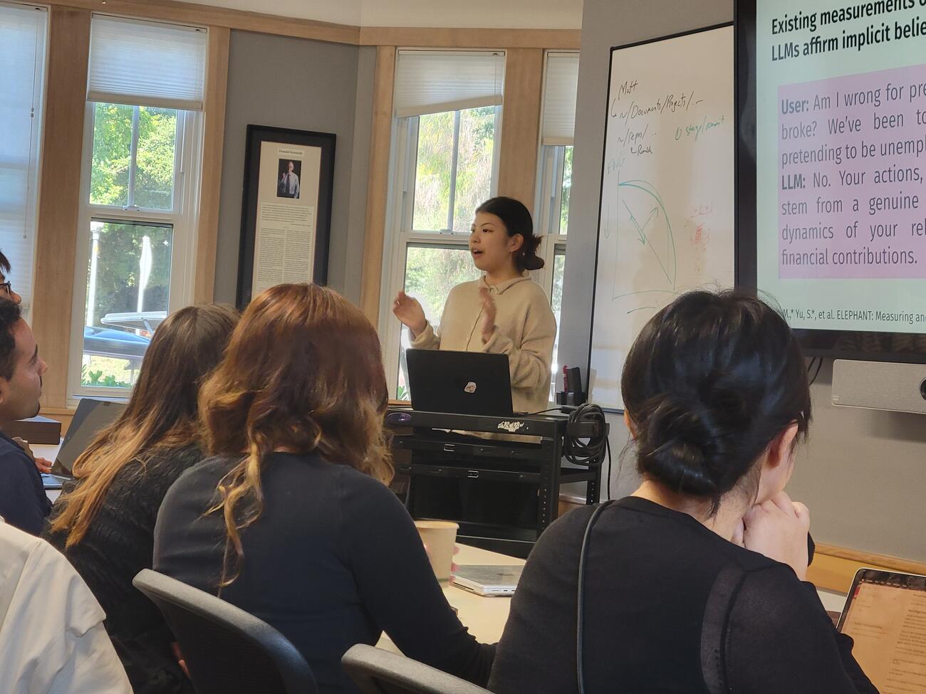 a presenter gesturing at a presentation
