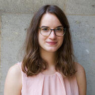 Anja Stevic smiling, wearing a pink shirt and glasses