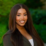 Headshot of MIP Student Kylie Jones with green background