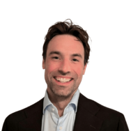 Man in dress shirt and jacket smiling