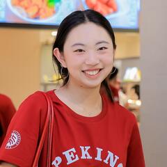 Adeline stands in a food hall. 