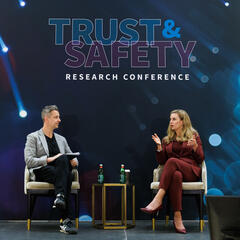 photo of two speakers at conference on a stage