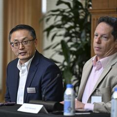 Shanjun Li and Scott Kennedy sit on a panel for an event. 