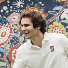 Alexandre smiles while playing in a school yard.