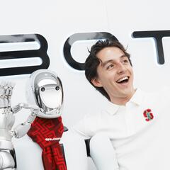 Jaxon poses with a robot at Galbot showroom. 