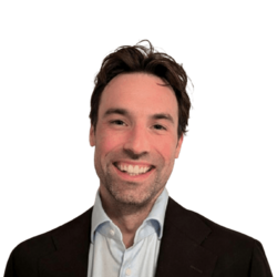 Man in dress shirt and jacket smiling