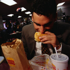 A man eating a hamburger at Burger King