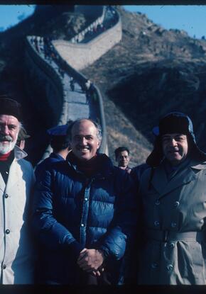three people standing at the great wall in China