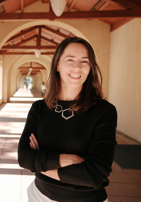 Stanford's Maria Polyakova stands amid the university's sandstone columns.