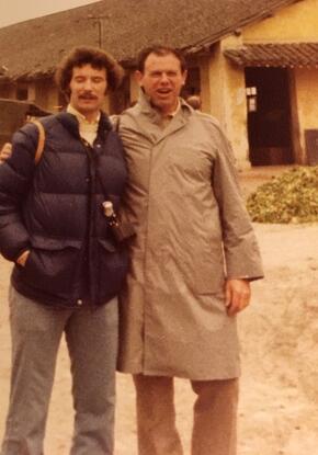 two men in jackets standing