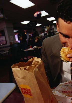 A man eating a hamburger at Burger King