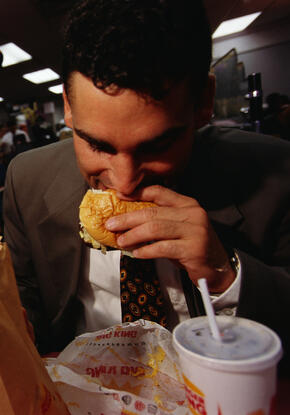 A man eating a hamburger at Burger King