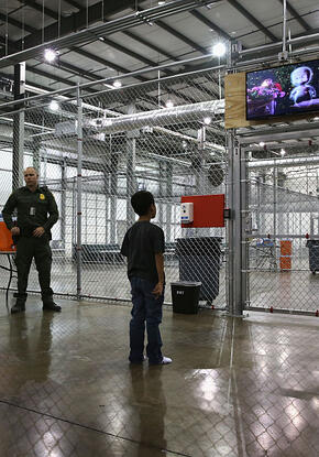 Boy watches a movie in U.S. detention center