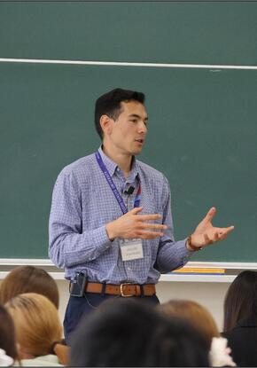 a person giving a talk in front of a class