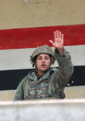 Soldier in front of Syrian flag