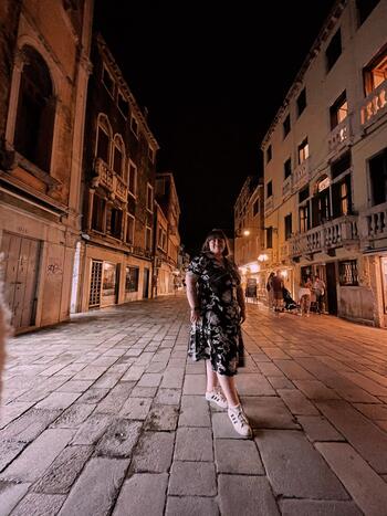 Hannah Johnston in a building lined street in Italy