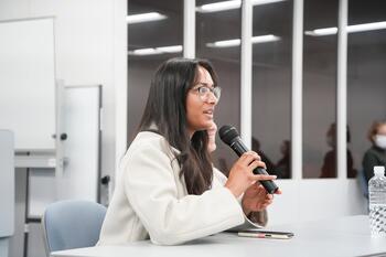 Photo of woman speaking into a microphone