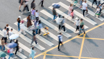 Photo of people in China walking in a crosswalk