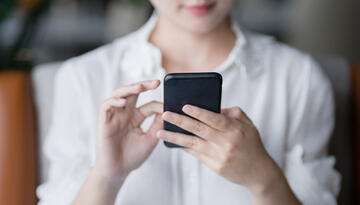 Photo of woman persuing social media on phone