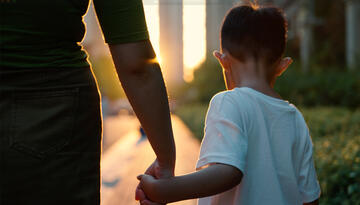 Feature image showing single child with parent in China