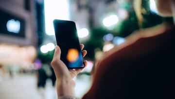 Feature figure showing women looking at cell phone