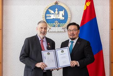 Professor James S. Fishkin was presented with the Medal of Friendship certificate by Zandanshatar Gombojav.