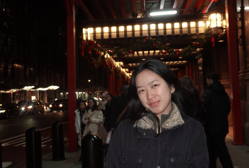 person standing in the street at night 