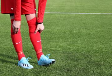 A person in a red and blue football uniform on a field