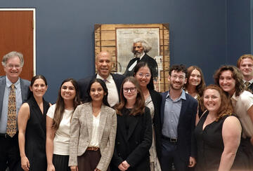 The Fisher Family Honors Program Class of 2026 and faculty pose with Senator Cory Booker.